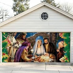 a garage door with a painting of the birth of jesus on it's side