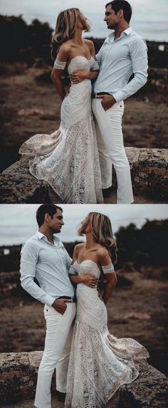 two people standing next to each other in front of the ocean and one person wearing white