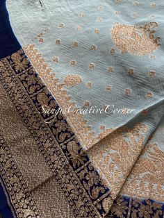 WELCOME to Sangi's Ancient threads where you step into elegance with any of our handlooms and hand embroiled pieces.  The an unique and rare color combination- storm blue/grey with an antique border (navy blue) combo! This is a pure and beautiful Khaddi Georgette silk woven (see below for the history) silk saree with vibrant weaving all through out the saree with small buttis and border of the saree is a an antique zari with dark navy blue hues within the border. The intricate gold work weaved t Elegant Raw Silk Sets With Motifs, Elegant Tissue Silk Saree With Motifs, Elegant Cotton Silk Blouse Piece With Motifs, Elegant Blue Sets With Zari Weaving, Elegant Sets With Motifs For Celebration, Elegant Tissue Silk Dupatta With Motifs, Wedding Blouse Piece In Cotton Silk With Motifs, Wedding Cotton Silk Blouse Piece With Motifs, Elegant Blue Sets With Motifs