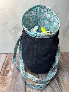 a bag with toothbrushes in it sitting on a wooden floor