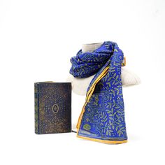 Royal blue is matched with gilt gold to produce an elegant design of detailed line-work. Let others revel at your royal scarf, as you relish the rightful admiration over your fine fashion taste. Inspiration: Poetical Works of Byron, c.1900 Vintage Blue Silk Scarf As Gift, Blue Vintage Silk Scarf For Gift, Vintage Blue Silk Scarf For Gift, Elegant Ceremonial Shawl, Classic Gold Silk Scarf, Blue Vintage Silk Scarf For Formal Occasions, Vintage Blue Silk Scarf For Formal Occasions, Blue Traditional Scarves For Festive Season, Traditional Blue Scarf As Gift