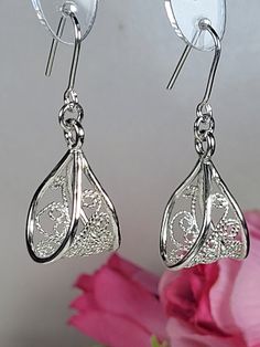 Filigree earrings made by intricate metal work, creating a rich floral and dainty look. The art nouveau earrings are inspired by Art nouveau jewelry combined with modern design. These floral dangle earrings are perfect for a beloved woman, and as a pampering gift for yourself. The earrings are very flattering, comfortable to wear as a jewel for everyday use and impressive as a jewel for a special occasion. The structure of the earrings is approximately 20 mm long, creating an elegant and unique style. The earrings are made of 925 sterling silver by hand tools only. Each piece of jewelry is handmade to order, therefor due to the special nature of handcrafting, there may be slight differences compared to the jewelry in the photos shown. This adds to the charm and individuality of each piece, Ornate Sterling Silver Earrings With Elegant Design, Ornate Drop Earrings For Gifts, Ornate Drop Earrings Gift, Exquisite Sterling Silver Earrings With Intricate Design, Filigree Chandelier Earrings As Gift, Exquisite Filigree Earrings For Gift, Filigree Drop Earrings As A Gift, Gift Filigree Drop Earrings, Handmade Art Nouveau Drop Earrings Jewelry