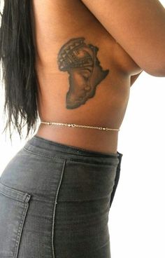 a woman with a tattoo on her back showing the side view of her body and shoulder