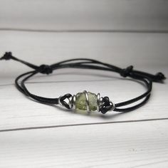 Real Czech Moldavite Wire Wrapped Into A Stainless Steel Wire Cage And Put On An Adjustable Black Cotton Cord 1mm Bracelet. Fits 4.5-9.5" This Is A Production Piece, So Will Look Similar But Not Exact. Most Focals Are Between .6-.75" Wide. I Also Have This In Steel, Silver, Bronze And Hold Listings. Boho Wire Wrapped Jewelry, Stainless Steel Wire Jewelry, Wire Wrapped Rocks, Wire Wrapped Jewelry Beginner, Wire Wrap Jewelry Designs, Hammered Jewelry, Moldavite Jewelry, Wire Wrapping Stones, Wire Wrapped Bracelet