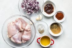 the ingredients for this dish include chicken, onions, spices and seasoning in bowls