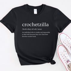 Dealing with a crochetzilla can be challenging as their frustration over losing their favorite crochet hook adds an extra layer of difficulty to the situation. If you or someone you know embodies the spirit of a crochetzilla, then this tee is a perfect fit. Product Details: Experience a fresh take on casual comfort with this unisex soft-style Gildan t-shirt. Crafted from exceptionally soft materials, this tee is 100% cotton for solid colors. Heather colors consist of 35% ring-spun cotton and 65% Black Crochet Cotton Top, Unisex Crochet, Shirt Crochet, Crochet Gift, Crochet Hook, T Shirt Funny, Soft Style, Crochet Hooks, Solid Colors