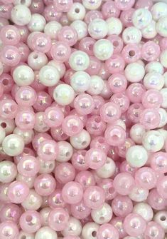 some pink and white beads are in a pile