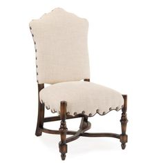 an upholstered chair with wooden legs and buttons on the back, against a white background