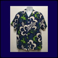 "Vintage 1960s bark cloth tiki hawaiian shirt by Evelyn Margolis hawaii. Size medium/large The bark cloth cotton shirt has an abstract bold floral/ tiki style design in shades of blues, lime green and white. The bark cloth cotton shirt has a pointed collar, five button down front, short sleeves and one patch pocket. Label states Evelyn Margolis hawaii The shirt is in vintage condition and sold as is. Please see pictures above showing small stains on front of shirt. MEASUREMENTS: (All measurement Fitted Hawaiian Shirt For Vacation, Cotton Hawaiian Shirt With Vintage Print, Vintage Green Camp Shirt For The Beach, Vintage Green Camp Shirt For Beach, Vintage Cotton Hawaiian Shirt With Tropical Print, Hawaiian Shirt With Vintage Print And Camp Collar, Hawaiian Vintage Print Beach Shirt, Fitted Hawaiian Shirt With Camp Collar, Vintage Short Sleeve Camp Shirt With Hibiscus Print