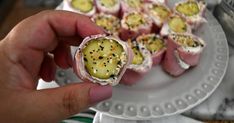 a person is holding some food on a plate