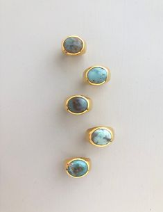 Modern Turquoise Jewelry, Gold Turquoise Oval Cabochon Ring, Gold Oval Cabochon Turquoise Ring, Gold Ring With Large Oval Cabochon Stone, Luxury Oval Rings With Natural Stones, Oval Yellow Gold Rings With Natural Stones, Modern Oval Turquoise Gemstone Ring, Modern Oval Turquoise Ring As Gift, Gold Turquoise Ring With Oval Cabochon