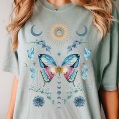 🩴 Beautiful Watercolor Whimsigoth Butterfly Shirt. Celestial figures, florals, crystals, moon and stars surround a gorgeous butterfly on this t-shirt. Perfect gift for fans of Goblincore, Fairy Core, Cottage Core, and Light Academia. 🩴 Click here to view our shop for more great designs --- https://www.etsy.com/shop/GraceAndFlipFlops Click on the ❤️ to see our new designs as they arrive. 🩴 Comfort Colors T-Shirt - The unisex cotton tee is the perfect staple of any wardrobe. The Unisex relaxed Summer Fairy Grunge T-shirt With Crew Neck, Fairy Grunge Graphic T-shirt For Summer, Fairycore Short Sleeve Tops For Spring, Summer Fairycore Top With Graphic Print, Fairycore Graphic Print Short Sleeve T-shirt, Summer Fairycore Crew Neck T-shirt, Cotton Fairycore T-shirt For Summer, Summer Fairycore Cotton T-shirt, Fairycore Cotton T-shirt With Graphic Print