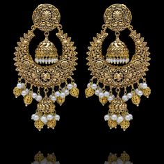 A fun pair with classic deign that never goes out-of-style! Gorgeous pair of earrings that is a perfect pick to pull-off any traditional or ethnic look. With its beautiful metal carving, embossed details and timeless jhumki design with an addition to pearl moti, this pair is all you need for the upcoming events. Kajal Earrings are available in two sizes. Big earrings are about 4.5" long and small earrings are about 3" long. Gold-plated on high-quality brass as base metal. Delivery time frame is Heavy Chandbali Earrings In Brass, Brass Earrings With Intricate Design For Festivals, Heavy Chandbali Brass Earrings, Brass Chandbalis With Intricate Design, Festival Brass Earrings With Intricate Design, Metal Chandbali Earrings With Filigree, Brass Chandbali Chandelier Earrings For Pierced Ears, Metal Chandbali Chandelier Earrings With Intricate Design, Filigree Chandbali Earrings