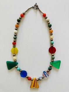 This beautiful necklace was designed to celebrate color. I used triangle, sphere, and hexagon beads to emphasize each different color. All the beads are sustainable and the product is ethically made. Multicolor Recycled Glass Beads For Jewelry Making, Multicolor Recycled Glass Jewelry For Jewelry Making, Handmade Multicolor Necklaces From Recycled Glass, Handmade Multicolor Necklace From Recycled Glass, Multicolor Recycled Glass Bead Jewelry, Multicolor Recycled Glass Beaded Jewelry, Multicolor Recycled Glass Jewelry With Large Beads, Colorful Beaded Necklace Of Recycled Glass For Gifts, Colorful Recycled Glass Beaded Necklace As Gift