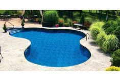 an above ground swimming pool surrounded by landscaping