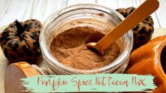 an image of pumpkin spice hot cocoa mix in a glass jar with spoon on the side