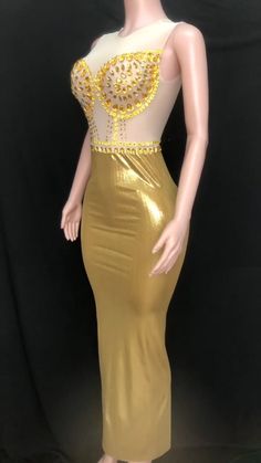 Introducing our stunning handmade Golden Graduation Gown, a masterpiece of elegance and glamour. Crafted with meticulous attention to detail, this gown is designed to make you shine on your special day. Made from a luxurious blend of spandex and polyester, this gown offers a perfect balance of comfort and style. The fabric drapes beautifully, enhancing your silhouette and allowing you to move with grace. Breathable and sustainable, this gown ensures you stay comfortable throughout your graduation ceremony. The fabric allows for airflow, keeping you cool and confident as you receive your well-deserved accolades. The empire waistline adds a touch of regal charm, creating a flattering and elongating effect. It accentuates your figure and adds an element of sophistication to your overall look. Fitted Backless Gown For Gala, Glamorous Fitted Ball Gown With Sweep Train, Gold Backless Maxi Dress For Prom, Stretch Maxi Length Wedding Gown, Stretch Maxi-length Wedding Gown, Fitted Ball Gown For Gala Party, Fitted Ball Gown For Party And Gala, Fitted Maxi Dress For Wedding And Party Season, Fitted Floor-length Gala Gown