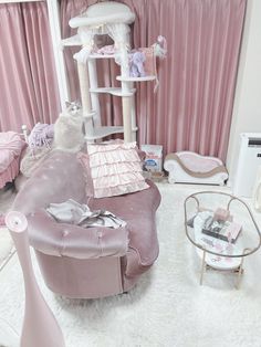 a living room filled with furniture and pink curtains