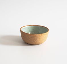 a small bowl sitting on top of a white table