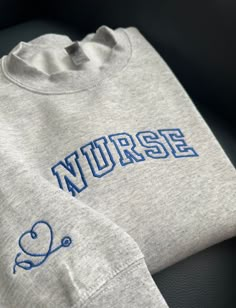 a grey sweatshirt with the word nurse on it