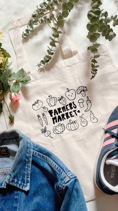 A embroidered Farmers Market design on a organic cotton tote bag. Eco-friendly Embroidered Cotton Bags, Rectangular Cotton Canvas Bag For Market, Embroidered Cotton Eco-friendly Bags, Everyday Cotton Bag With Embroidery, Everyday Embroidered Canvas Tote Bag, Eco-friendly Embroidered Cotton Canvas Bag, Eco-friendly Embroidered Canvas Bag For Daily Use, Eco-friendly White Embroidered Canvas Bag, Cotton Canvas Tote Bag With Embroidered Logo