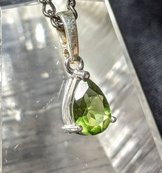 "🌠 GENUINE FACETED TEARDROP MOLDAVITE NECKLACE in 925 Sterling Silver🌠 You will love this Beautiful and ELEGANT Moldavite pendant with Gorgeous natural green colors. Top quality precision faceting highlights this authentic 22mm by 8mm moldavite pendant! Awesome oval shape set in 925 Sterling Silver. It comes with an awesome \"gunmetal\" colored chain (choose your length in the dropdown menu) made in our studio. This will be a treasured go to pendant for years to come. A Shine Crystals top pick Sterling Silver Drop Jewelry For May Birthstone, Classic Green Teardrop Pendant Jewelry, 925 Stamped Drop Jewelry For Anniversary, Classic Green Teardrop Pendant Necklace, Stamped 925 Teardrop Pendant Necklace For Anniversary, Silver Drop Jewelry For May Birthstone, Classic Pear-shaped Sterling Silver Drop Necklace, Sterling Silver Gemstone Drop Necklace, Classic Teardrop Gemstone Necklace