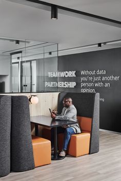 a man sitting at a table in an office