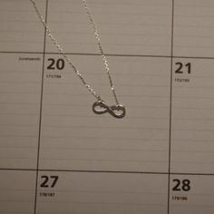 a calendar with a necklace on it and the date is twenty two thirty three,