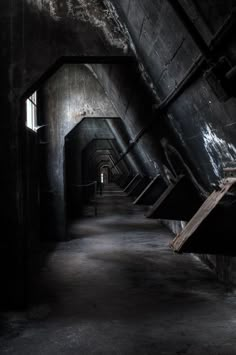 an empty dark tunnel with stairs leading up to it