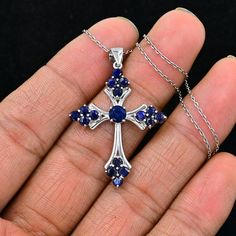 "925 Sterling Silver, Natural Sapphire Cross Pendant, Holy Cross Pendant Necklace, September Birthstone, Sapphire Jewelry, Gift For Birthday.  ►Made of solid sterling silver with a rhodium finish (925) ● Code --- HC-195 ● Main Stone --- Natural Blue Sapphire ● Birthstone Month --- September ● Color --- Blue ● Gem Size --- 3 MM/3 MM ● Carat Weight --- 3.10 ct. (approx.) ● Total Weight --- 5.95 Gram ● Gemstone Creation --- 100% Natural ● Accented Stone --- White Topaz ● Pendant Length --- 1.60 Inch ● Pendant Width --- 1.10 Inch Some of the amazing additional features of this product: ● Fine, professional cut natural gemstones - not synthetic, lab created, nor simulated ● Elegant, makes beautiful engagement gift; anniversary gift; bridesmaid gift; gift for girlfriend; gifts for mom; gift for Silver Sapphire Necklace Hallmarked, Spiritual 925 Stamped Jewelry For Memorials, Sterling Silver Cross Necklace With Birthstone, Hallmarked Sapphire Necklaces As A Gift, Hallmarked Sapphire Necklace For Gift, Silver Cross Pendant Jewelry For Mother's Day, Silver Sapphire Jewelry For Jewelry Making, Mother's Day Sterling Silver Cross Pendant Jewelry, Mother's Day Sterling Silver Cross Pendant