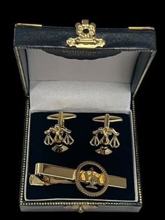 A stunning set of Legal Scales of Justice Cufflinks and Tie Clip lavished in 24k Gold LAW GOLD  CUFFLINK SET Very high quality set of cufflinks -  - A very nice weight, super detail and crafted to last indefinitely. The detail is beautiful. LAW TIE CLIP As with the cufflinks, this exquisite tie clip has been stripped to the base metal and lavished in multiple layers of certified 24k gold. Sealed and polished. Includes detailed hand signed and dated certificate pertaining to the gold plating. The certificate is housed in a gold envelope.  Presented in a beautiful, luxurious double gift case with metal fittings and press-button brass clasp and corners, British Gold Company branded and double boxed. Shipped within 24 hours insured and tracked delivery to your door  PLEASE NOTE: Shipping costs Luxury Gold Clip-on Cufflinks, Elegant Suit And Tie Accessories Gift Box, Elegant Silver Sets For Gift, Elegant Silver Sets For Gifts, Elegant Cufflinks In Gift Box For Father's Day, Elegant Cufflinks With Gift Box For Father's Day, Elegant Father's Day Cufflinks In Gift Box, Classic Gold Sets For Business, Gold Jewelry With Hallmark For Wedding Gift