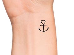 an anchor with a heart tattoo on the wrist