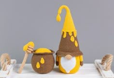 two crocheted gnomes sitting next to each other