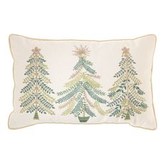 a white pillow with green trees on the front and bottom, along with a gold trimming