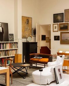 a living room filled with furniture and bookshelves