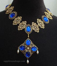 Wear a piece of history with this "Mary, Queen of Scots" movie-inspired reproduction Tudor necklace. Crafted with ornate gold-tone filigrees and captivating acrylic cabochons, this regal accessory adds unique glamor to any look. Necklace length is 17-18", with a 2-3" extender attached. Longer and shorter lengths available upon request, message me with your desired length. Glenda Jackson, Medieval Necklace, Queen Of Scots, Iron Jewelry, Mary Queen Of Scots, Medieval Jewelry, Medieval Period, Necklace Collection, Elizabeth I