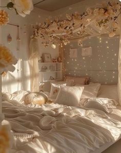 a white bed topped with lots of pillows next to a window covered in curtains and lights