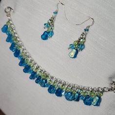 Turn Your Volume Up! Handmade Sensory Bracelet 7.5" Long Silver Tone Delicate Chain Loaded With Dangles Of Czech Glass Tulip Beads. Half The Dangles Have A Blue Glass Diamond Bead And The Other Half Have A Green Crystal Bead, And A Beautiful "Beachglass" Like Blue Tulip Pressed Czech Glass Bead With Aurora Borealis Finish. Toggle Clasp Coordinating Earrings Included, Silver Tone French Wire Hooks, 2" Long For Pierced Ears, Each With A Tulips And Crystals. New To Poshmark?? Use Code Plumloved To Handmade Adjustable Blue-green Jewelry, Blue Glass Jewelry With Dangling Beads, Adjustable Blue Bracelets With Dangling Beads, Adjustable Beaded Blue Jewelry Set, Blue Czech Glass Dangle Jewelry, Blue Beaded Bracelets With Dangling Beads For Gift, Handmade Blue Dangle Jewelry Sets, Handmade Blue Jewelry Sets With Dangle Shape, Adjustable Blue Jewelry Sets For Party