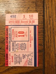 an old concert ticket is sitting on a wooden table with the word upper deck reserved $ 6 00