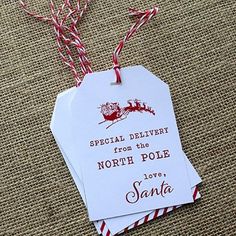 two tags that say special delivery from the north pole to santa on top of some twine