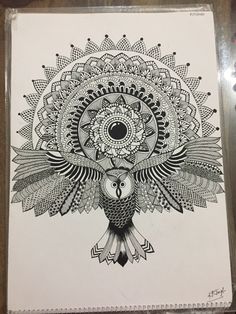 an owl is sitting on top of a piece of paper with intricate designs in the background