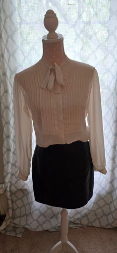 Lovely Necktie Sheer Cream Blouse from Saks Fifth Avenue Size 10 This is such a great Victorian style vintage blouse.  It is sheer and has pleating on the front. There is a concealed button band that makes this blouse even more elegant. This blouse is from the 1980's.   100 % Polyester.   I paired it with a great leather skirt that is also listed in my shop.  *Skirt is not included Comes from a smoke free and pet free home. Shop Skirt, Cream Blouse, Womens Blouses, Vintage Blouse, Blouse Vintage, Victorian Style, Victorian Fashion, Saks Fifth, Saks Fifth Avenue