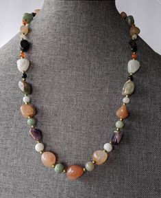 "Multi Gemstone Nugget Necklace Vintage beaded necklace featuring Amethyst, Carnelian, Agate, Black Onyx, Rose Quartz nuggets with brass spacer beads. Necklace has older style barrel clasp. Necklace will arrive gift boxed. * HALLMARKS Unmarked. * MEASUREMENTS 24\" long with 13 to 7mm beads * CONDITION Excellent. * MATERIALS Multi semi precious gemstones." Luxury Traditional Agate Beaded Necklace, Vintage Natural Stones Gemstones For Gift, Vintage Natural Stones Gemstones As Gift, Vintage Natural Gemstones As Gifts, Vintage Multicolor Gemstone Beads And Cabochons, Tumbled Natural Stone Beaded Necklace As Gift, Vintage Jade Necklace With Natural Stones, Vintage Gemstone Necklace For Healing, Vintage Healing Gemstone Necklace