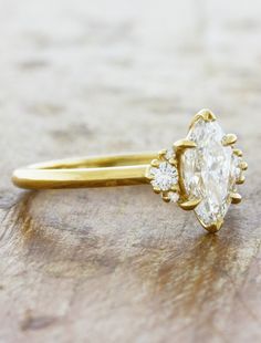 a yellow gold engagement ring with an oval cut diamond