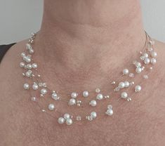 Beautiful handmade Multi strand floating necklace.  This necklace has been made using white faux pearls and Austrian crystal bicone beads, threaded onto a nylon coated stainless steel wire, finished off with a lobster clasp closure and a 5cm extension chain for added length if needed. The necklace is available in two lengths, either 42cm or 47cm, not including the extension chain Your necklace will be packaged in a lovely gift box, perfect for a gift. -Please note that standard shipping (2nd Class) will not include tracking 📦✈  For International deliveries: They will be sent by Royal Mail International Standard Shipping which says 6-7 working days but can take up to 14 business days at times. Please note there is no tracking on International standard post For European deliveries: Also Sta Pearl Necklace Layered, Multi Strand Beaded Necklace, Crystals Beads, Floating Necklace, Necklace Layered, Crystal Bead Necklace, Wire Necklace, White Crystals, Necklace Pearl