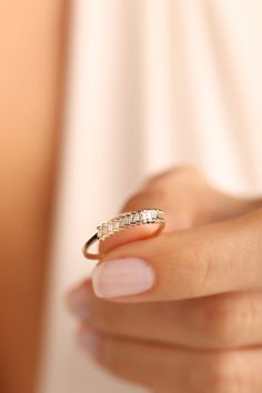 a woman's hand with a gold ring on it