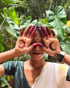 a woman holding her hands up to her face