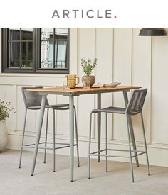 two chairs and a table in front of a window with the words article on it