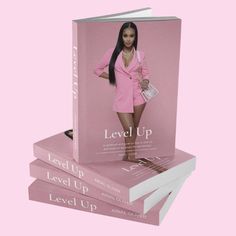 the book level up is stacked on top of each other, with an image of a woman in a pink suit