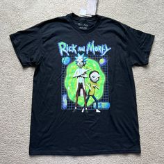 Brand New With Tags Size Large Rick And Morty T-Shirt Black Short Sleeve Logo Graphic Shirt Top Tee Large New Black Shirt With Character Print Relaxed Fit, Trendy Black Shirt For Fan Merchandise, Casual Black Shirt With Character Print, Trendy Black Shirt With Character Print, Black Tops With Cartoon Print For Fans, Black Top With Cartoon Print And Relaxed Fit, Black Tops With Cartoon Print In Relaxed Fit, Black Pop Culture Top With Cartoon Print, Black Pop Culture Top With Letter Print